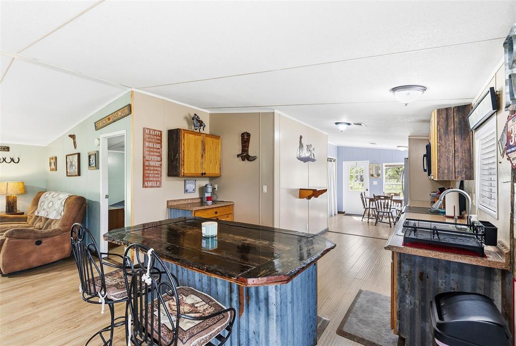 3591 North Canoe Creek Road Kenansville, FL 34739 - Photo 16 of 42 a kitchen with sink and chairs