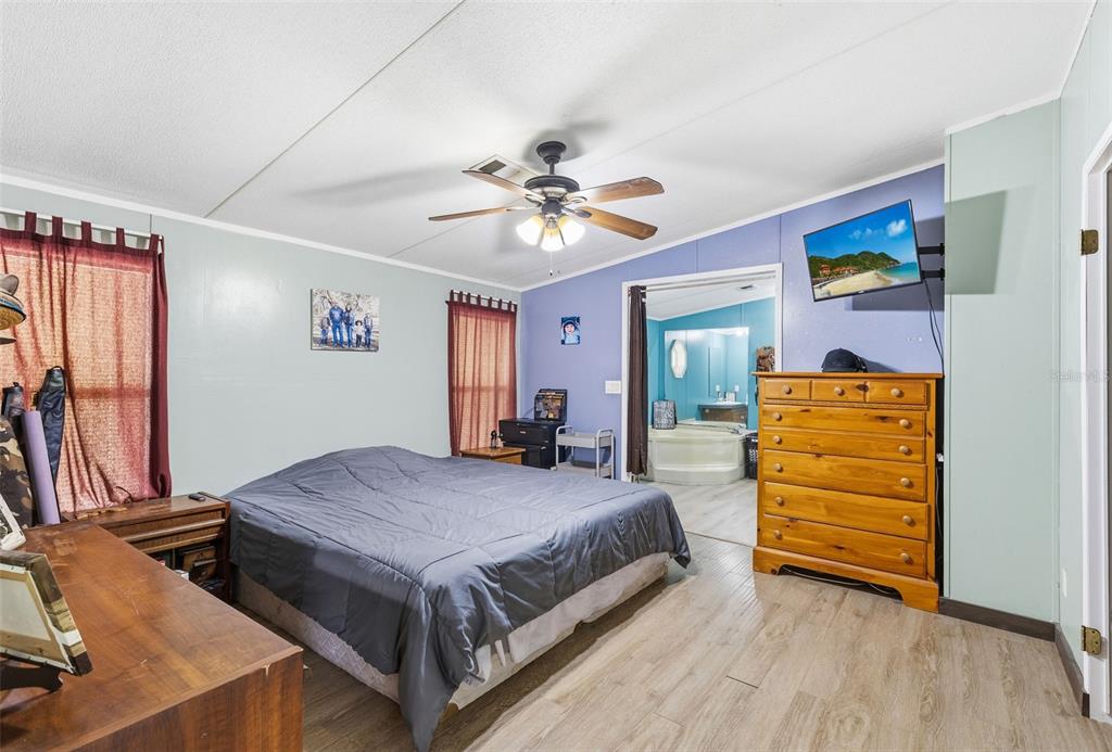 3591 North Canoe Creek Road Kenansville, FL 34739 - Photo 17 of 42 a bedroom with a bed and a dresser