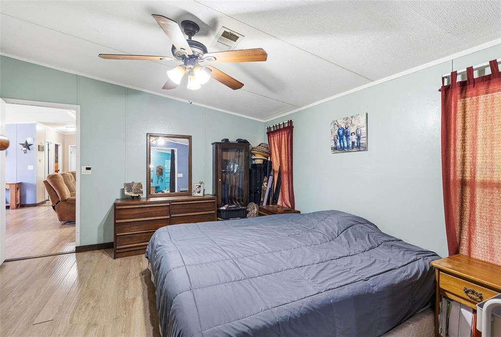 3591 North Canoe Creek Road Kenansville, FL 34739 - Photo 18 of 42 a bedroom with a bed and a chandelier
