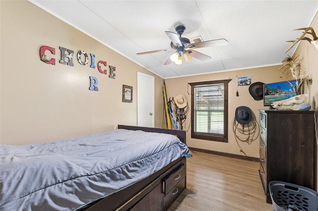 3591 North Canoe Creek Road Kenansville, FL 34739 - Photo 21 of 42 a bedroom with a bed and a window