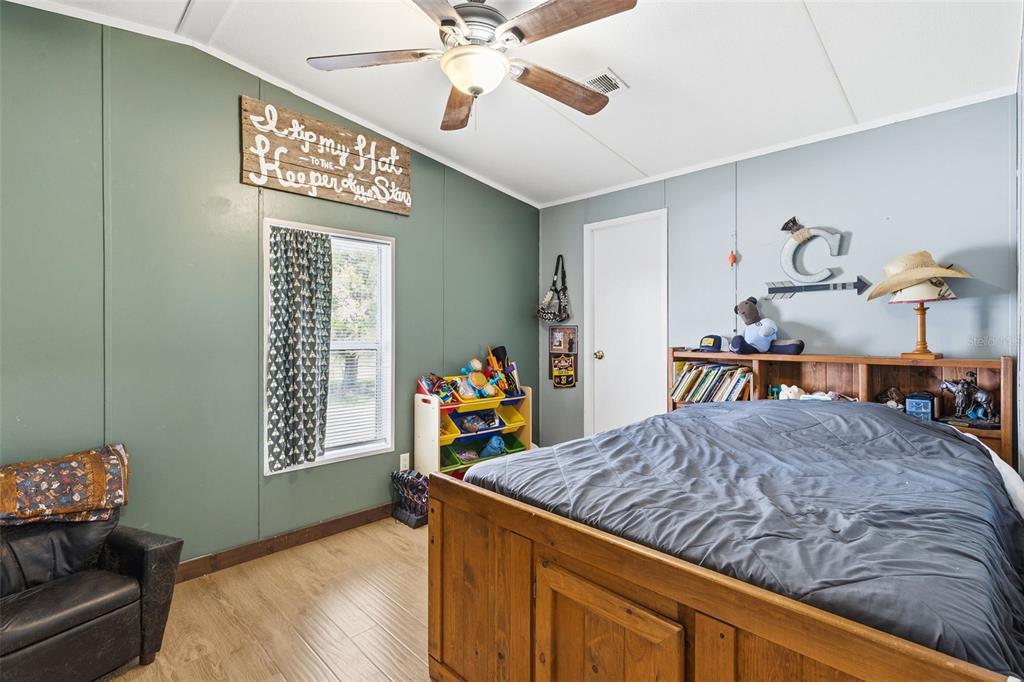 3591 North Canoe Creek Road Kenansville, FL 34739 - Photo 22 of 42 a bedroom with a bed dresser and a window