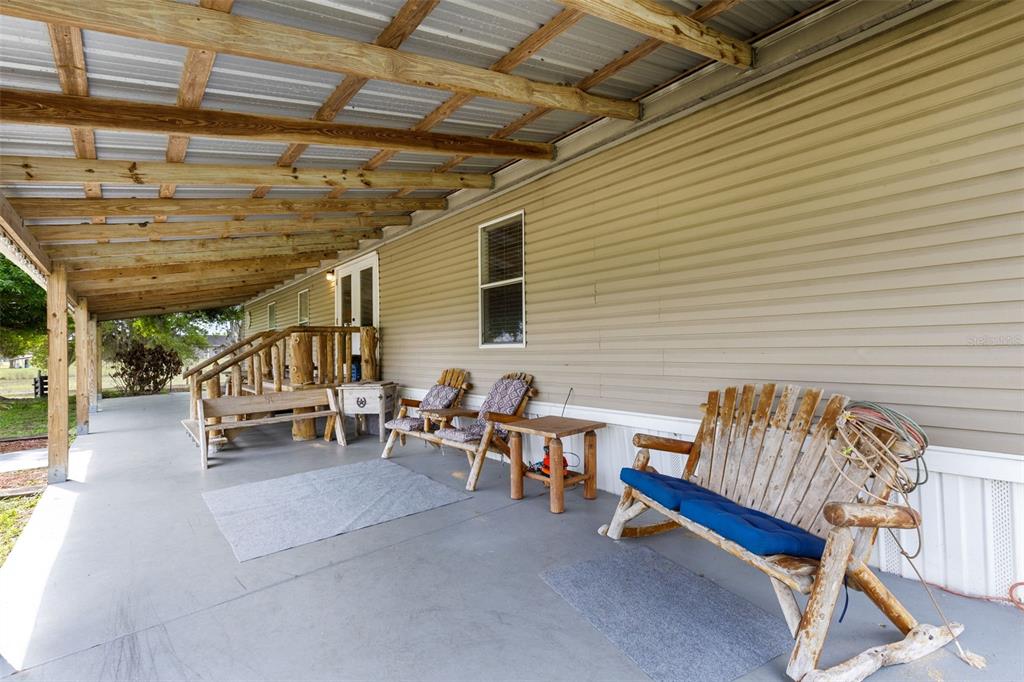 3591 North Canoe Creek Road Kenansville, FL 34739 - Photo 25 of 42 a roof deck with table and chairs