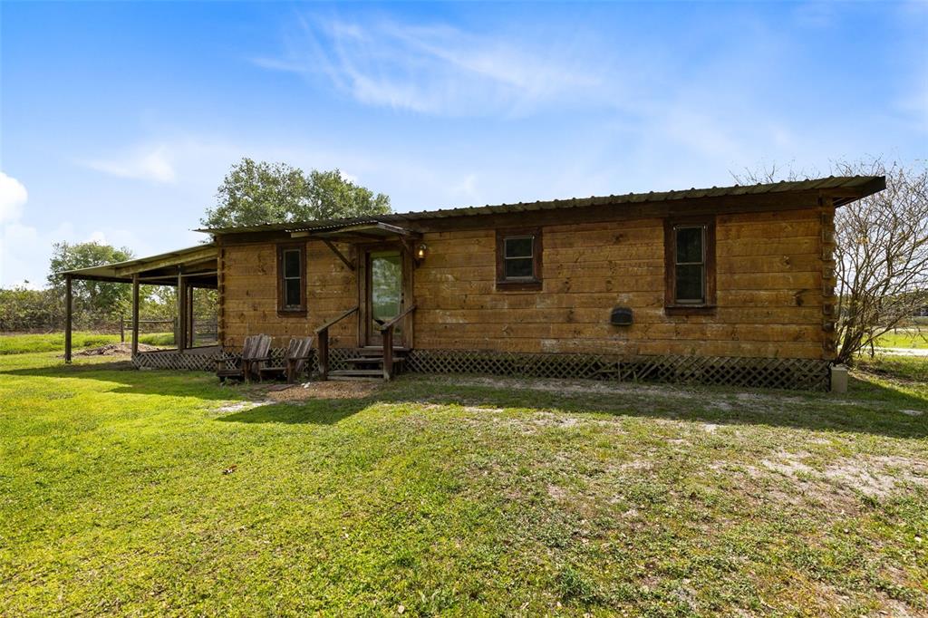 3591 North Canoe Creek Road Kenansville, FL 34739 - Photo 32 of 42 a backyard of a house with yard table and chairs
