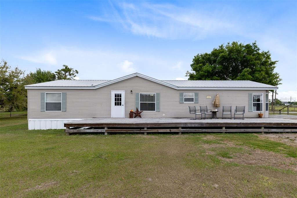 3591 North Canoe Creek Road Kenansville, FL 34739 - Photo 6 of 42 a front view of a house with a boat
