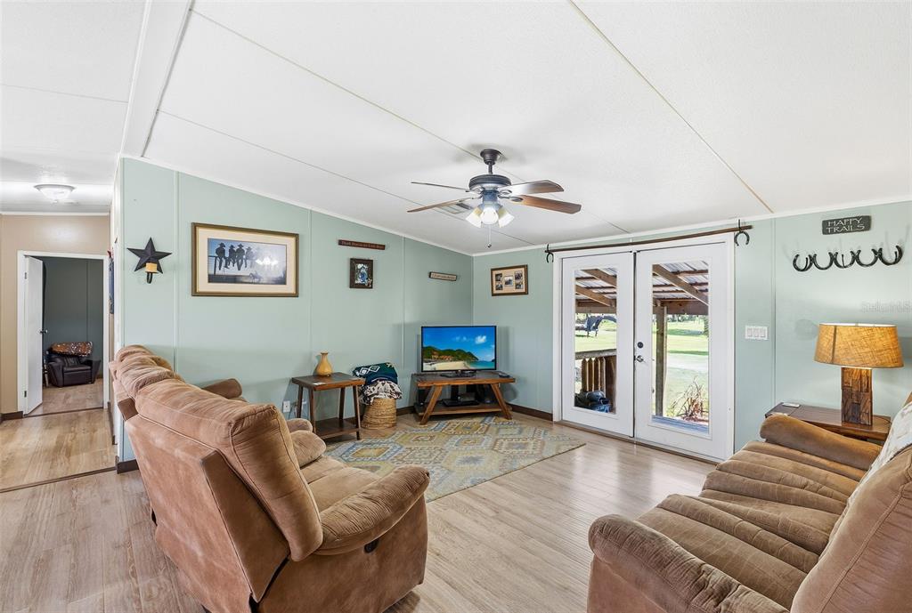 3591 North Canoe Creek Road Kenansville, FL 34739 - Photo 9 of 42 a living room with furniture and wooden floor