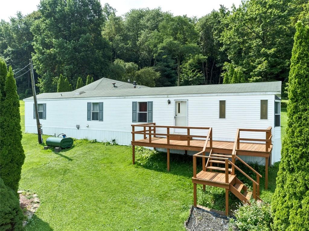 423 Quail Hill Road Normalville, PA 15469 - Photo 1 of 28 a view of a white house with a yard and sitting area