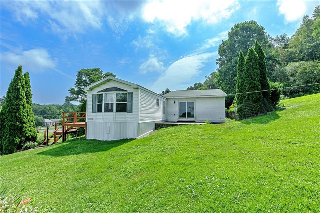 423 Quail Hill Road Normalville, PA 15469 - Photo 8 of 28 a front view of a house with garden