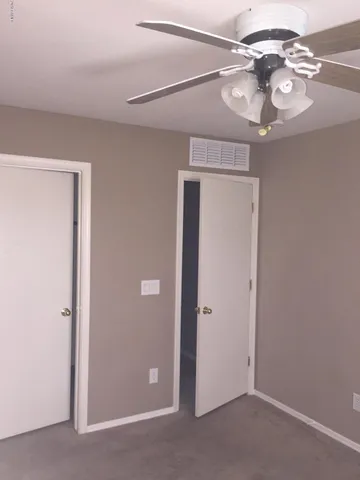 a view of a chandelier fan and a window