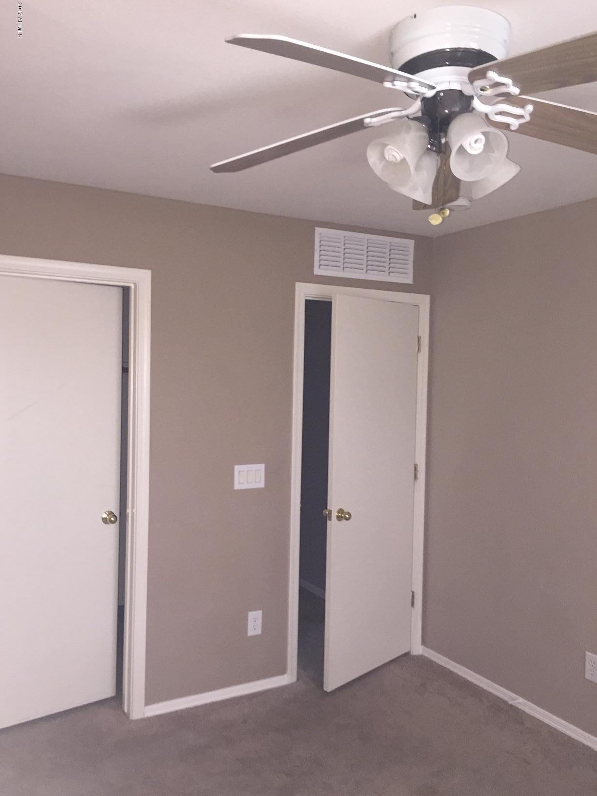 17544 West Hearn Road Surprise, AZ 85388 - Photo 9 of 17 a view of a chandelier fan and a window