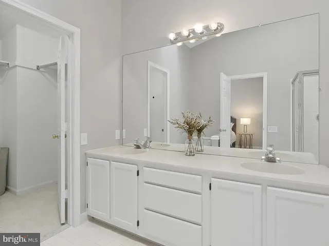 a bathroom with a double vanity sink and a mirror