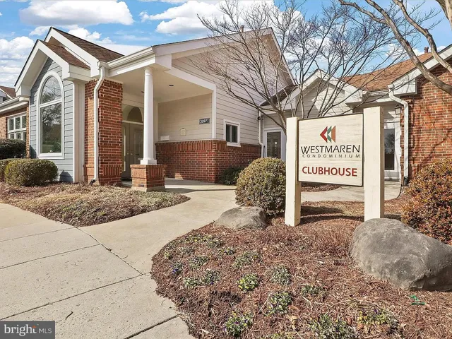 a view of a white house with a yard covered in snow