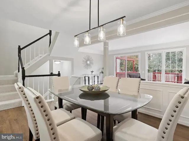 a view of a dining room with furniture and a large window