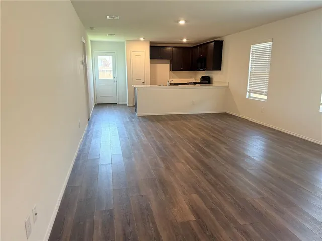 a view of kitchen with wooden floor and electronic appliances