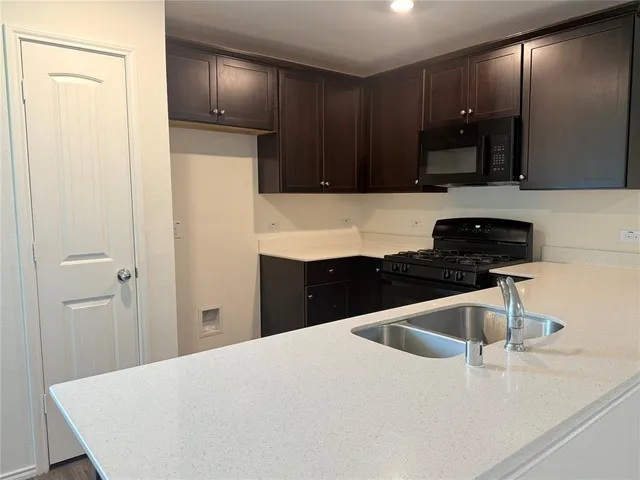 a kitchen with a sink and a refrigerator
