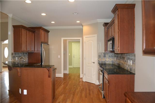 1606 Fair House Road Spring Hill, TN 37174 - Photo 5 of 20 Kitchen - Tile Backsplash, Pantry, Hardwood flooring, Recessed Lighting