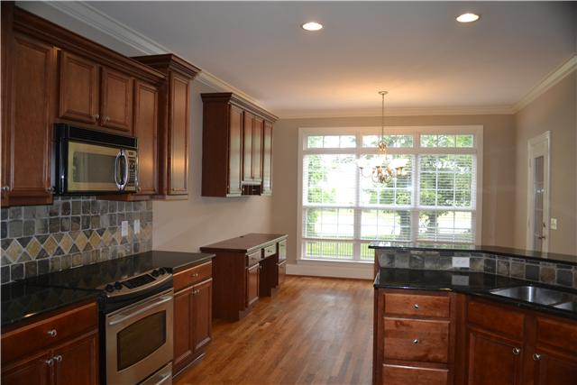 1606 Fair House Road Spring Hill, TN 37174 - Photo 7 of 20 Kitchen - Lots of cabinetry! Smooth top range and Microwave hood; Tech area in the Eat-in area.