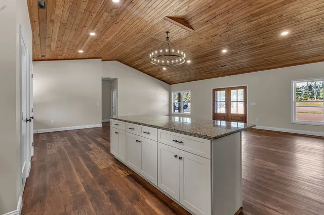 a view of a kitchen with cabinets and wooden floor