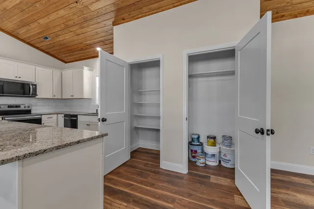 a kitchen with stainless steel appliances granite countertop a refrigerator and a stove top oven