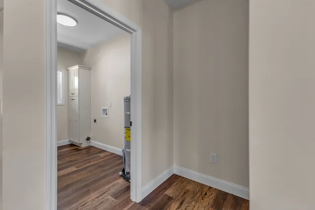 a view of a room with wooden floor