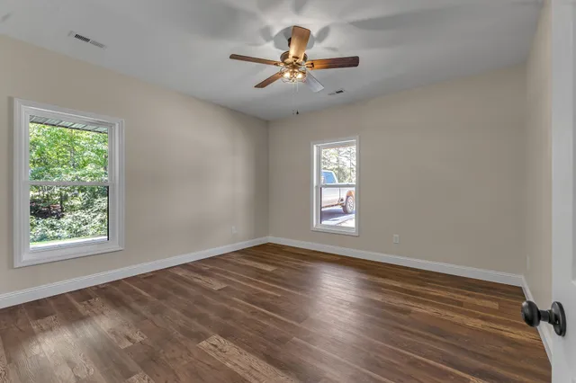 wooden floor in an empty room with a window
