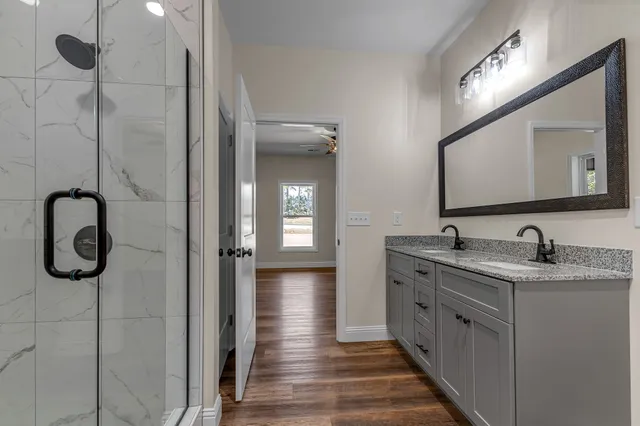 a bathroom with a double vanity sink and a mirror