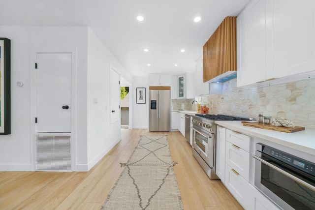 a bedroom with a large bed and a large window