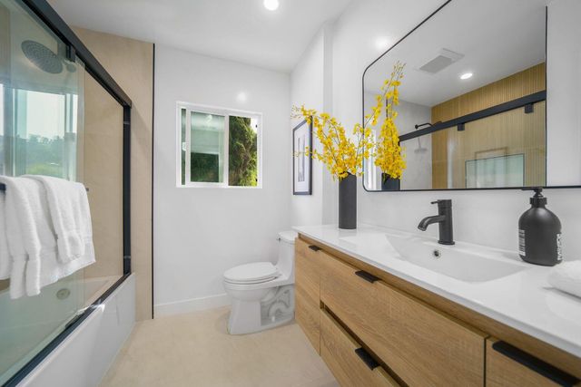 a view of a storage and utility room with washer and dryer