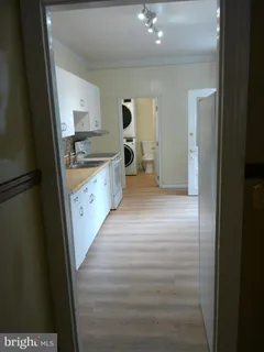 a kitchen with stainless steel appliances a sink and cabinets