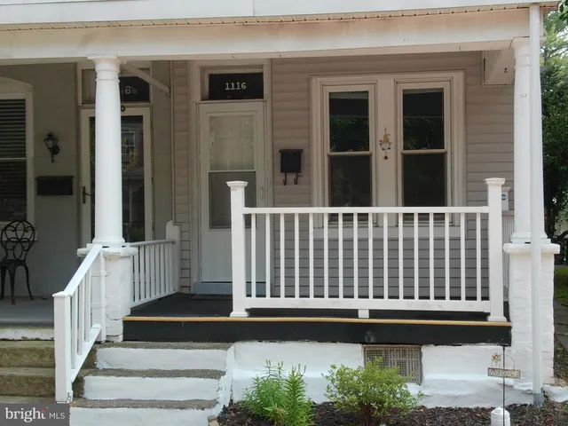 a view of a house with a small deck