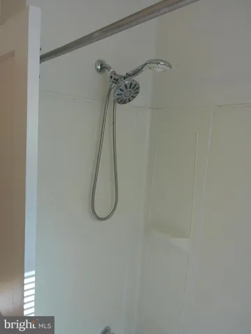 a view of a small space with wooden floor and a window