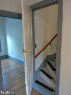 a view of a room with rack on the wall and a window