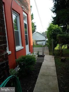 a backyard of a house with table and chairs