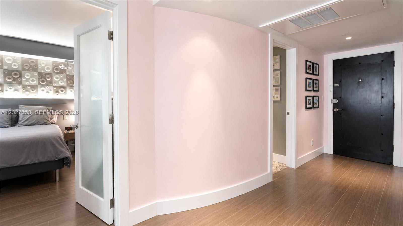 100 Lincoln Road, Unit 533 Miami Beach, FL 33139 - Photo 10 of 26 a view of bedroom with a bed wooden floor and window
