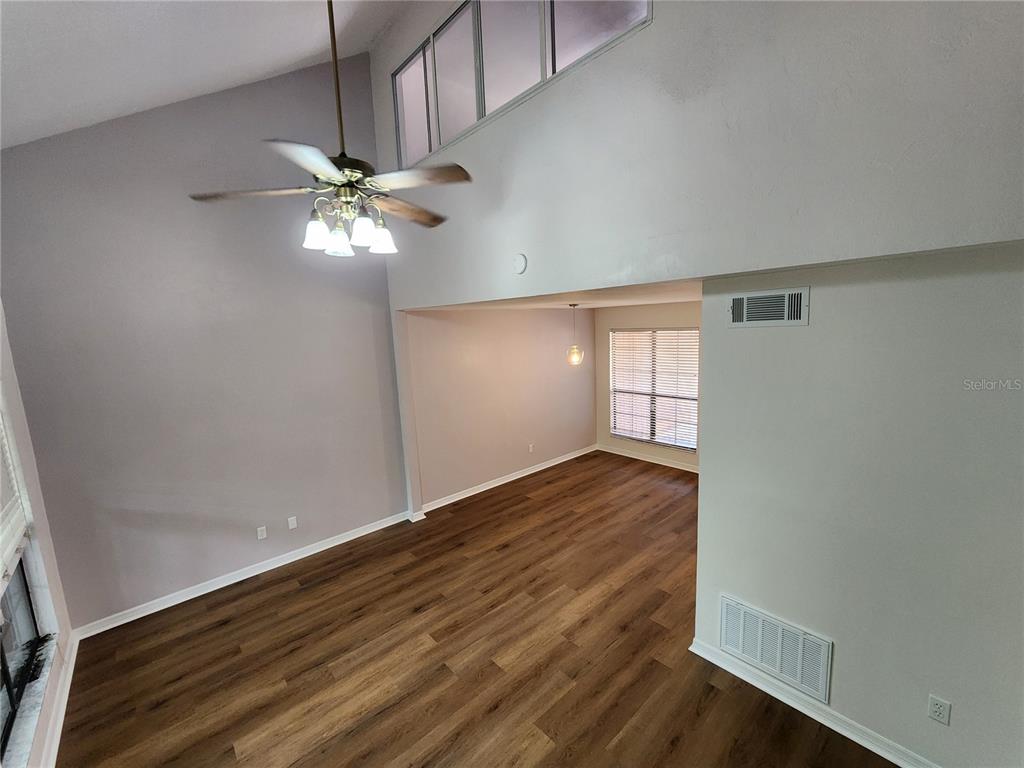 5823 Southwest 9th Place, Unit H55 Gainesville, FL 32607 - Photo 40 of 50 wooden floor in an empty room with a window