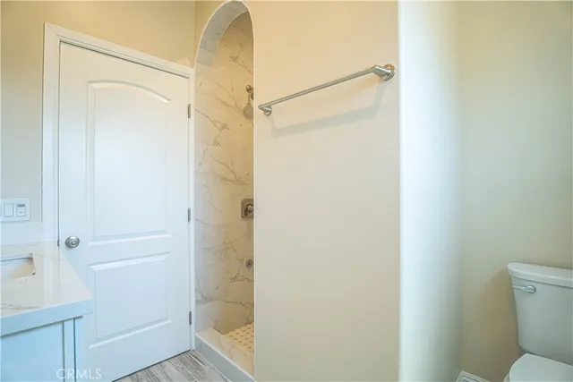 a bathroom that has a glass shower door