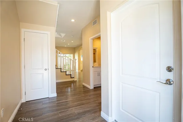 a view of a hallway with wooden floor