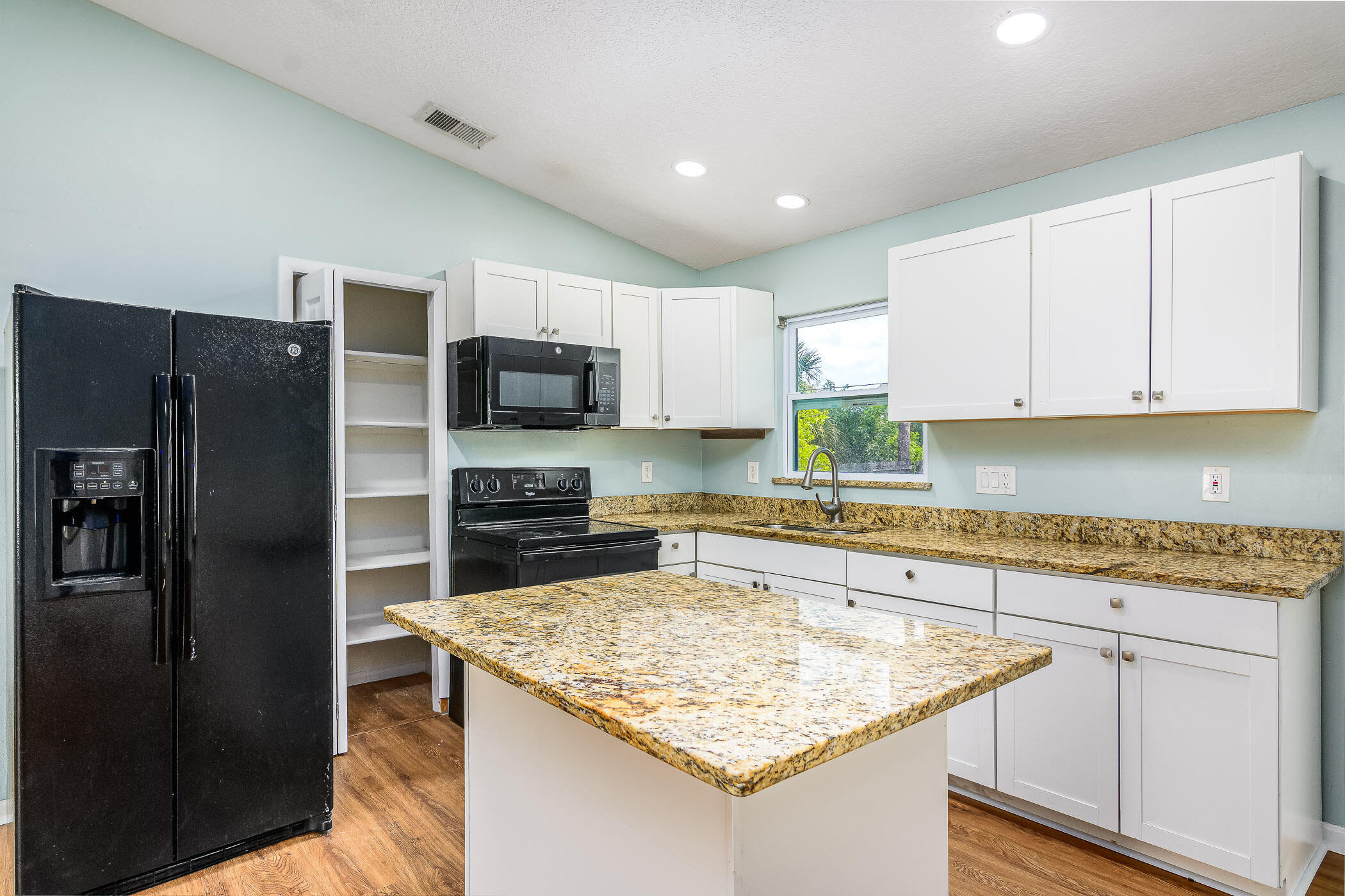 565 Town Road Southwest Palm Bay, FL 32908 - Photo 10 of 37 Granite counters and white cabinets