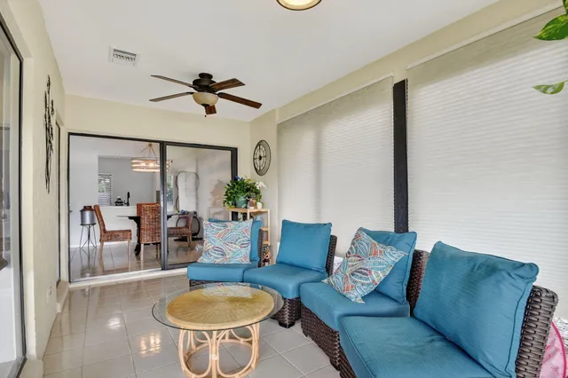 a balcony with furniture and a floor to ceiling window