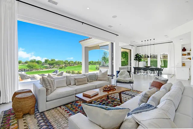 a dining room with furniture a chandelier and window