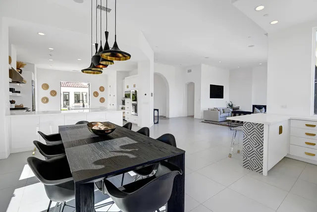 a kitchen with stainless steel appliances cabinets and a dining table