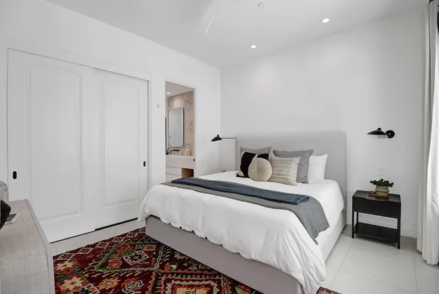 a bedroom with a bed and chair