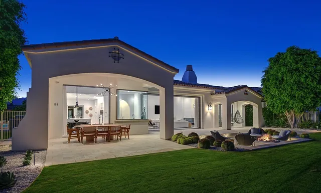 a view of a house with backyard porch and sitting area