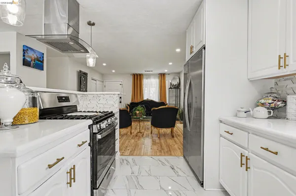 a kitchen with a stove and a refrigerator