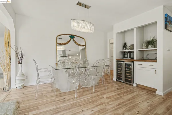 a living room with furniture a fireplace and kitchen view
