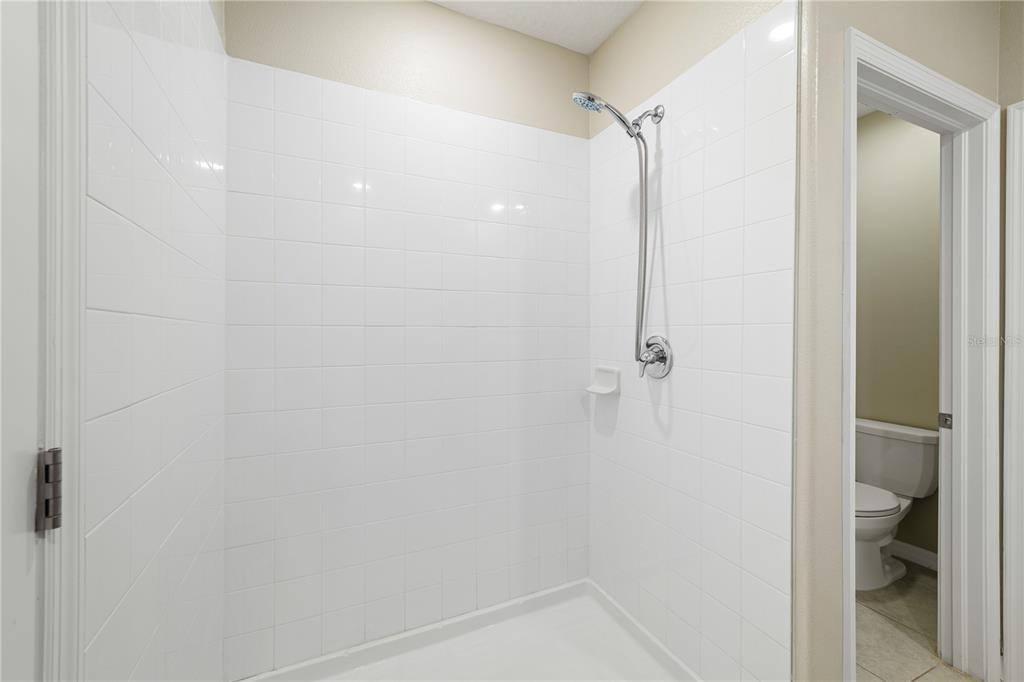 9448 Lemon Drop Loop Ruskin, FL 33573 - Photo 12 of 28 a bathroom with a shower