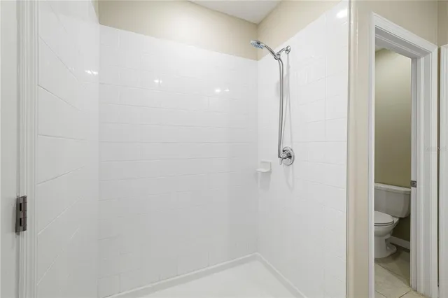 a bathroom with a granite countertop sink a mirror and a shower