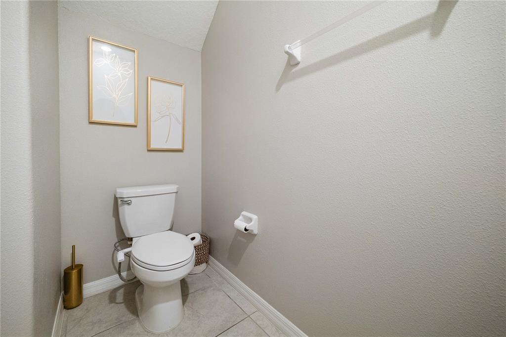 9448 Lemon Drop Loop Ruskin, FL 33573 - Photo 16 of 28 a white toilet sitting next to a white cabinet