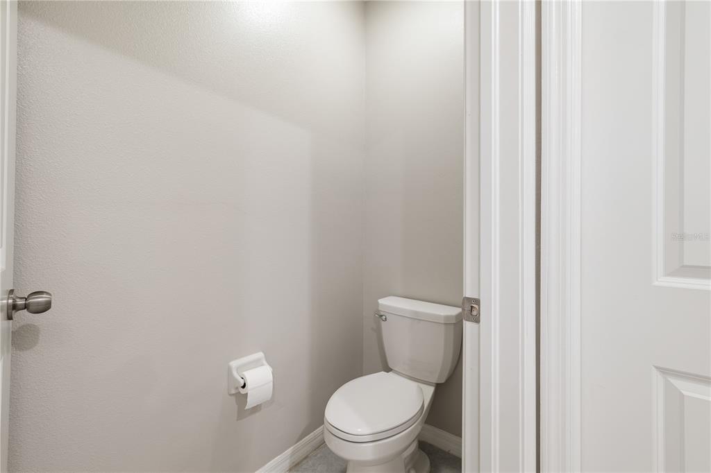 9448 Lemon Drop Loop Ruskin, FL 33573 - Photo 17 of 28 a white toilet sitting next to a white wall