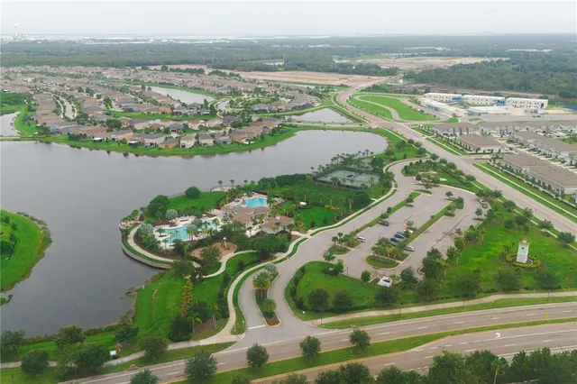 an aerial view of residential houses with outdoor space and swimming pool