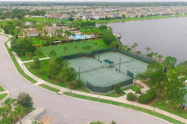 a view of a swimming pool with a yard from a balcony